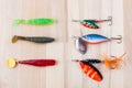 Various fishing accessories, silicone jig and metal spoon, and  on wooden background, 23 november 2020, Gothenburg, Sweden Royalty Free Stock Photo