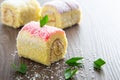 Various flavour swiss roll cake on wooden table Royalty Free Stock Photo