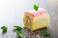 Various flavour swiss roll cake on wooden table Royalty Free Stock Photo