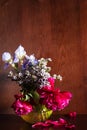 Various flowers in vase on dark brown background Royalty Free Stock Photo