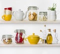 Various food ingredients and utensils on kitchen shelves isolated