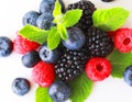 Various fresh berries isolated on white background. Raspberry, Blueberry, Cranberry, Blackberry and Mint leaves Royalty Free Stock Photo