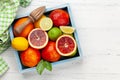 Various fresh citrus fruits in box. Bood orange, lime, lemon Royalty Free Stock Photo