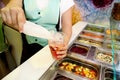 Various fresh fruit and vegetable salad bar healthy items. Hand is preparing fruits for organic smoothie. Royalty Free Stock Photo