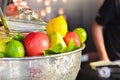 Various fresh fruits and vegetables in steel basket, yellow lemon and green lemon and red apple and pear on the bar Royalty Free Stock Photo