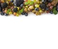 Various fresh summer berries and fruits on white background. Ripe grape, blueberries, blackberries, plums. Berries and fruits at b Royalty Free Stock Photo