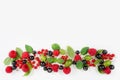 Various fresh summer berries. Ripe raspberries, currants, gooseberries, mint and basil leaves.