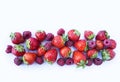 Various fresh summer berries. Ripe strawberries and raspberries isolated on white background. Top view. Berries at border of image Royalty Free Stock Photo