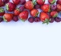 Various fresh summer berries. Ripe strawberries and raspberries on white background. Top view. Berries at border of image with cop Royalty Free Stock Photo