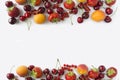 Ripe strawberries, redcurrants, apricots and cherries on white background.