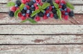 Various fresh summer berries on wooden background. Royalty Free Stock Photo