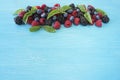 Various fresh summer berries on wooden background. Royalty Free Stock Photo