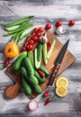 Various fresh vegetables with cutting board on wooden background Royalty Free Stock Photo