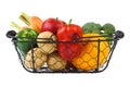 Various fresh vegetables and fruits in a wire basket. Isolated Royalty Free Stock Photo