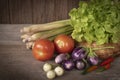 Various fresh, young homegrown vegetables, tomato, lemon grass, chilli, lettuce, Eggplant place on a wooden table