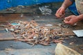 Various freshly just caught fish on a fishing wooden boat with pieces of plastic or microplastic