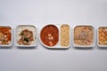 Various frozen meal in plastic tray on white background. Royalty Free Stock Photo