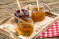 Various fruit marmalade jams in jars top view. Honey, apricot jam and strawberry jam in jars Royalty Free Stock Photo