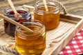 Various fruit marmalade jams in jars top view. Honey, apricot jam and strawberry jam in jars