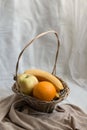 Various fruit in a wicker basket in a cozy space Royalty Free Stock Photo