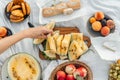 Fruits on white blanket, picnic outdoor. Yellow Watermelon. Royalty Free Stock Photo