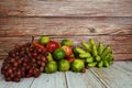 Various of fruits with Red grape, red apple, banana and green orange on wooden background Royalty Free Stock Photo