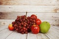 Various of fruits with Red grape, red apple and green orange on wooden background Royalty Free Stock Photo