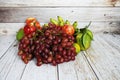 Various of fruits with Red grape, red apple and green orange on wooden background Royalty Free Stock Photo