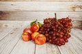 Various of fruits with Red grape, red apple and green orange on wooden background Royalty Free Stock Photo