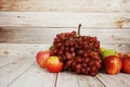 Various of fruits with Red grape, red apple and green orange on wooden background Royalty Free Stock Photo