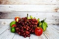 Various of fruits with Red grape, red apple and green orange on wooden background Royalty Free Stock Photo