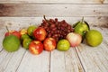 Various of fruits with Red grape, red apple and green orange on wooden background Royalty Free Stock Photo