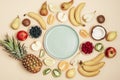 Various fruits on yellow background, blue plate in a center. Top view, flat lay, mockup. Tropical fruits, vegan food Royalty Free Stock Photo
