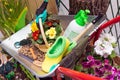 Various garden tools and decor. Household goods in a wheelbarrow trolley flowers, watering, goloshes, gloves, flower pot Royalty Free Stock Photo