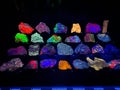 Various gem stones glow under fluorescent light Royalty Free Stock Photo