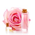 Various glass bottles with transparent liquid and pink rose Royalty Free Stock Photo