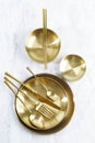 Various Gold Plate, Bowl, Spoon, and Fork on White Table, Food Photography Props Royalty Free Stock Photo