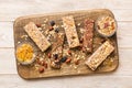 Various granola bars on table background. Cereal granola bars. Superfood breakfast bars with oats, nuts and berries Royalty Free Stock Photo