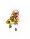 Various gummies and dried medical marijuana buds fell out of the embossed glass jar.