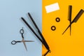 Various hair styling devices on the color blue, yellow paper background, top view Royalty Free Stock Photo