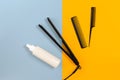 Various hair styling devices on the color blue, yellow paper background, top view