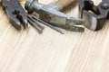 various hand tools and instruments including hammer, nails, pliers and pincers on wooden desk Royalty Free Stock Photo