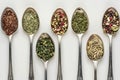 Various herbs and spices displayed in spoons, detailed and up close view for culinary enthusiasts