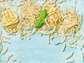 Various homemade fresh Italian pasta with flour and basil Royalty Free Stock Photo