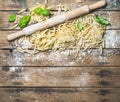 Various homemade fresh uncooked Italian pasta and plunger Royalty Free Stock Photo