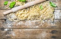 Various homemade fresh uncooked Italian pasta on wooden background Royalty Free Stock Photo