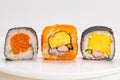 Various homemade japanese style sashimi sushi roll in white ceramic plate Royalty Free Stock Photo