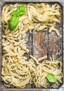 Various homemade uncooked Italian pasta in wooden tray Royalty Free Stock Photo