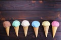 Various ice cream cones on wooden table, flat lay Royalty Free Stock Photo