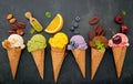 Various of ice cream flavor in cones blueberry ,green tea ,pistachio ,almond ,orange and cherry setup on dark stone background . Royalty Free Stock Photo